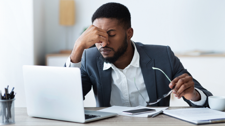 A man sitting at a desk looking disappointed.