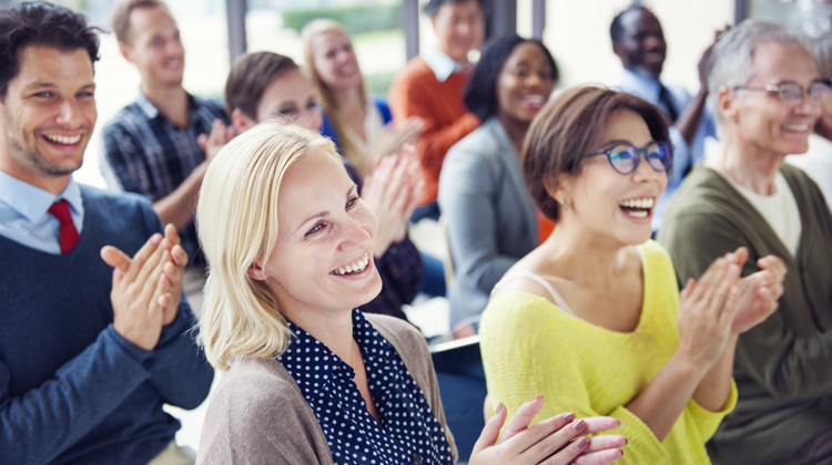 A group of people clapping.