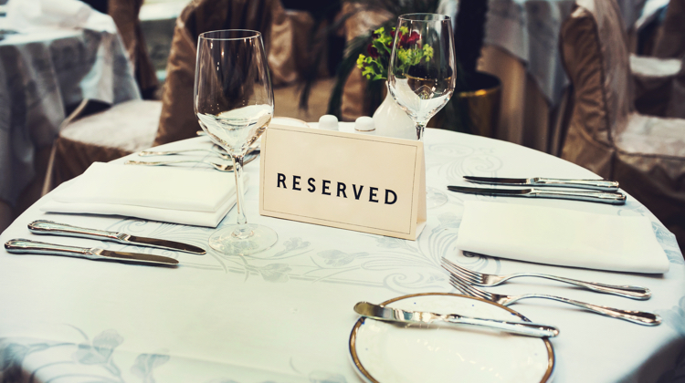 Formal table setting with a reserved sign; a client that hires you on a copywriting retainer reserves a certain number of hours of your time each week, whether or not they use it.