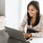 Woman smiling looking at computer screen