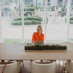 Nicki Krawczyk sitting in an empty conference room.