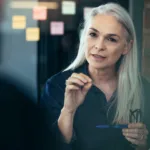 Woman talking to another person in an office.