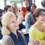 A group of people clapping.