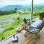 A woman working on a laptop while sitting