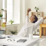 Woman stretches at her desk