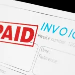 The word "invoice" appears in blue at the top of a page with "paid" stamped in red and outlined in a rectangle.